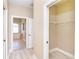 Hallway leads to closet space and primary bath featuring a soaking tub at 116 Hercules Dr, Rotonda West, FL 33947