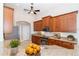 Warm kitchen with granite countertops, stainless steel appliances, plenty of cabinets, and a ceiling fan at 116 Hercules Dr, Rotonda West, FL 33947