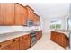 Kitchen featuring sleek stainless steel appliances and classic wood cabinetry at 116 Hercules Dr, Rotonda West, FL 33947