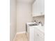 Laundry room with modern washer and dryer, white cabinets, and tile flooring at 116 Hercules Dr, Rotonda West, FL 33947