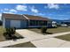 Cozy single-Gathering home featuring an attached garage, screened porch, and a neatly landscaped front yard at 13537 Bennett Dr, Port Charlotte, FL 33981