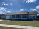 Charming single-story home with a well-maintained lawn and a screened front porch, perfect for enjoying outdoor living at 13537 Bennett Dr, Port Charlotte, FL 33981