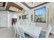 Dining room showcasing detailed ceiling, grand window view, and stylish white furniture set at 14448 Edna Cir, Port Charlotte, FL 33981