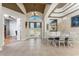 Bright dining area boasts tile floors, wainscotting detail, and elegant chandelier lighting at 14448 Edna Cir, Port Charlotte, FL 33981