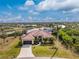 Stunning waterfront home featuring lush landscaping, mature palms and a private dock at 14448 Edna Cir, Port Charlotte, FL 33981