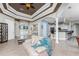 Open-concept living area with stylish furnishings, detailed ceilings, and seamless flow to the kitchen at 14448 Edna Cir, Port Charlotte, FL 33981