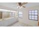 A light-filled bathroom features double vanity sinks, tile floors, a large mirror, and natural light at 3568 Middletown St, Port Charlotte, FL 33952