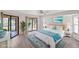 A large bedroom with light hardwood floors, sliding glass doors, and a beach-themed decor at 3568 Middletown St, Port Charlotte, FL 33952