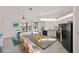 Bright kitchen featuring white cabinetry, stainless steel appliances, and an island with seating at 3568 Middletown St, Port Charlotte, FL 33952