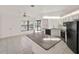 A kitchen featuring an island, tile flooring, and an attached dining area overlooking the backyard at 3568 Middletown St, Port Charlotte, FL 33952