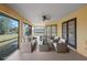 Covered lanai featuring comfortable seating and views of the backyard at 3568 Middletown St, Port Charlotte, FL 33952