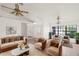 Bright living room featuring a plush sofa, two chairs, white walls and light-colored flooring at 3568 Middletown St, Port Charlotte, FL 33952