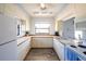 Well-maintained kitchen features bright cabinets, updated appliances, and a window that provides plenty of natural light at 4260 Placida Rd # 12C, Englewood, FL 34224