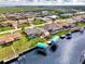 Aerial view of waterfront homes with canal access, boat docks, boat lifts, and pools at 5231 Conner Ter, Port Charlotte, FL 33981