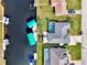 Aerial view of two houses with screened pools on a canal with boat docks and lifts at 5231 Conner Ter, Port Charlotte, FL 33981