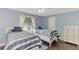 Charming bedroom features two twin beds with striped bedding and light blue walls at 5231 Conner Ter, Port Charlotte, FL 33981
