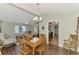 Bright dining area featuring hardwood floors and seamless transition to the kitchen and living areas at 5231 Conner Ter, Port Charlotte, FL 33981