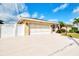Charming single-story home with a two-car garage, beautiful landscaping, and a spacious driveway at 5231 Conner Ter, Port Charlotte, FL 33981