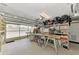 Spacious garage with ample storage shelving, tool bench and a Craftsman table saw at 5231 Conner Ter, Port Charlotte, FL 33981
