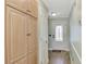 Hallway featuring storage cabinets and a door to the entryway with decorative glass at 5231 Conner Ter, Port Charlotte, FL 33981
