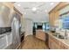 Spacious kitchen featuring stainless steel appliances, a view into other living areas, and a modern layout at 5231 Conner Ter, Port Charlotte, FL 33981