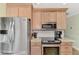 Modern kitchen with stainless steel appliances, stylish countertops, and ample storage space at 5231 Conner Ter, Port Charlotte, FL 33981
