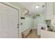 Functional laundry room with a sink, storage shelving, bench and a washer and dryer at 5231 Conner Ter, Port Charlotte, FL 33981