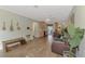 Spacious living room featuring wood-look tile flooring, neutral paint, and a blend of seating options at 5231 Conner Ter, Port Charlotte, FL 33981