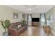 Inviting living room with wood-look tile flooring, comfortable seating, and bright natural light at 5231 Conner Ter, Port Charlotte, FL 33981