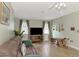 Bright living area with wood-look flooring, cozy seating, and natural light from large windows at 5231 Conner Ter, Port Charlotte, FL 33981