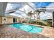 Refreshing pool surrounded by a screened enclosure and lush landscaping, perfect for enjoying outdoor living at 5231 Conner Ter, Port Charlotte, FL 33981