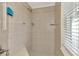 Tiled shower with a built-in seat and ample natural light from the window at 5231 Conner Ter, Port Charlotte, FL 33981