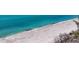 Stunning aerial view of a pristine beach with crystal-clear turquoise waters at 7475 Manasota Key Rd, Englewood, FL 34223