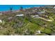 Aerial view of properties featuring lush greenery and waterfront access at 7475 Manasota Key Rd, Englewood, FL 34223