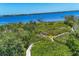 Aerial view of a waterfront property featuring a private dock and lush greenery at 7475 Manasota Key Rd, Englewood, FL 34223