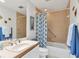 Well-lit bathroom featuring a vanity, bathtub with shower, and bright, cheerful decor at 7475 Manasota Key Rd, Englewood, FL 34223