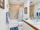 Cozy bathroom featuring a tub/shower combo, neutral tiles, and a sink with vanity at 7475 Manasota Key Rd, Englewood, FL 34223