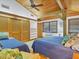 Cozy bedroom featuring wood ceiling, two beds, ample storage and a light, airy ambiance at 7475 Manasota Key Rd, Englewood, FL 34223