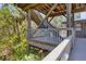 Outdoor deck featuring a table and chairs with wooden beam ceiling above at 7475 Manasota Key Rd, Englewood, FL 34223