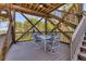 Relax on this covered deck featuring a dining set, with views framed by the wooden structure at 7475 Manasota Key Rd, Englewood, FL 34223