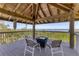 Breathtaking views from the covered deck, furnished with comfortable seating and a modern table at 7475 Manasota Key Rd, Englewood, FL 34223
