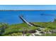 Private dock extending into the serene blue waters, perfect for boating and relaxation at 7475 Manasota Key Rd, Englewood, FL 34223