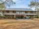 Stunning exterior view of a home elevated on stilts with a charming deck at 7475 Manasota Key Rd, Englewood, FL 34223