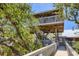 Unique home exterior with a stilted observation tower and a charming walkway at 7475 Manasota Key Rd, Englewood, FL 34223