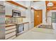 Modern kitchen featuring stainless steel appliances, stylish backsplash, and ample counter space at 7475 Manasota Key Rd, Englewood, FL 34223