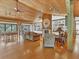 Spacious living area featuring a fireplace, built-in bookshelves, wood ceiling and an attached dining area at 7475 Manasota Key Rd, Englewood, FL 34223