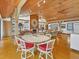 Bright and airy living room featuring fireplace, built-in shelving, and beautiful wood ceiling at 7475 Manasota Key Rd, Englewood, FL 34223