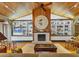 Cozy living room with a fireplace, built-in shelves, and a wood-paneled ceiling at 7475 Manasota Key Rd, Englewood, FL 34223
