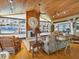Inviting living room with a fireplace, built-in shelves, and hardwood floors at 7475 Manasota Key Rd, Englewood, FL 34223