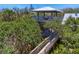 Elevated observation tower with connecting walkway surrounded by lush foliage and mature trees at 7475 Manasota Key Rd, Englewood, FL 34223
